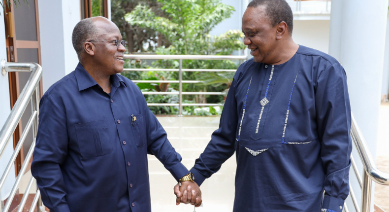 President John Magufuli holding hands with President Uhuru Kenyatta