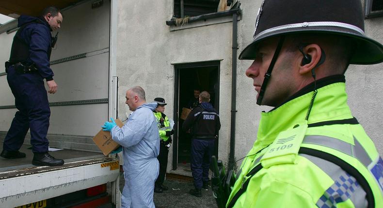 Police and forensic officers remove computers and related items from The Blade Internet Cafe, on Stratford Rd, as part of the on-going enquiry into anti-terror raids across the city to foil alleged 'Iraq-style' plot to kidnap and behead a British Muslim soldier, February 1, 2007, in Birmingham, England.