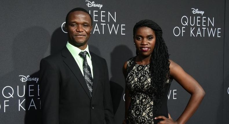 Robert Katende and Phiona Mutesi (R), whose life on which the story is based, pose on arrival for the premiere of Disney's Queen of Katwe in Hollywood, California on September 20, 2016