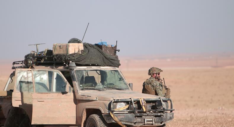 A US fighter near a military vehicle, north of Raqqa city, Syria, November 6, 2016.