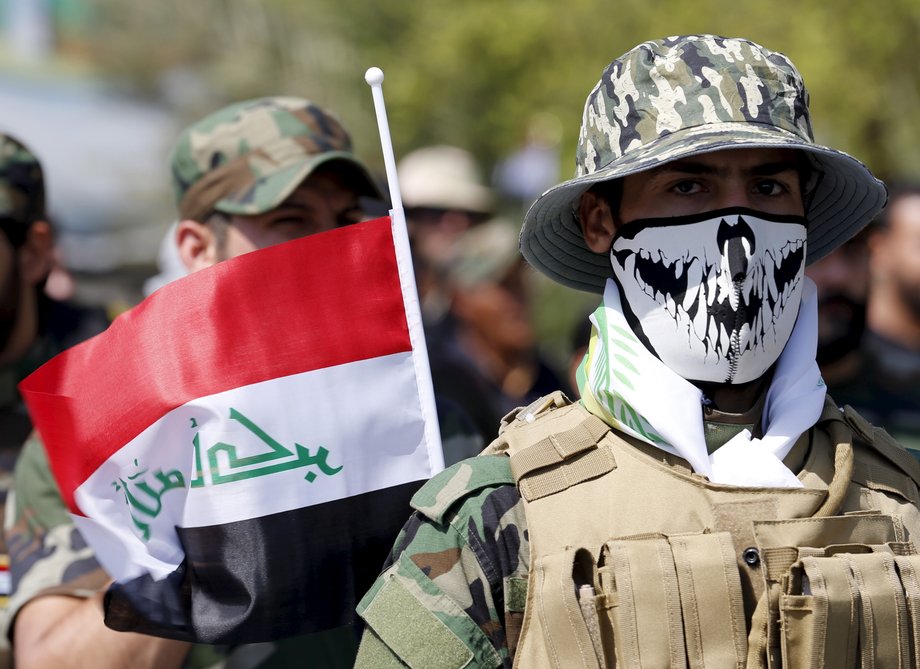 Iraqi Shiite Muslim men from Hashid Shaabi (Popular Mobilization) march during a parade marking the annual al-Quds Day, or Jerusalem Day, on the last Friday of the Muslim holy month of Ramadan in Baghdad, July 10, 2015.