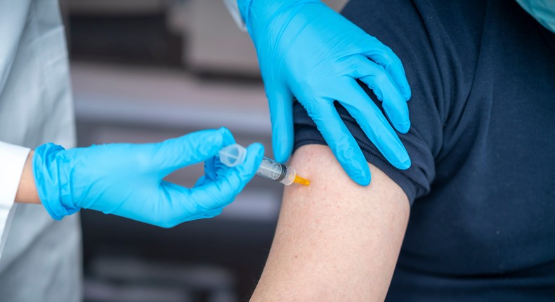 A stock image of a man receiving a vaccination in his arm.