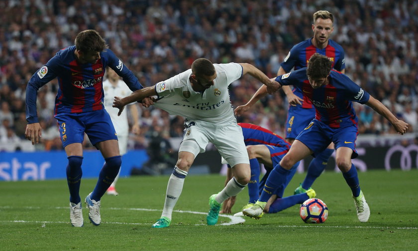 Real Madrid's Karim Benzema in action with Barcelona's Gerard Pique and Sergi Roberto