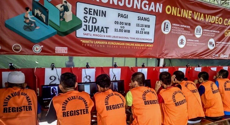 Indonesian inmates at a Jakarta prison talk via video to family members after visits were stopped because of coronavirus fears. Authorities have now gone further, and are releasing tens of thousands of prisoners in a bid to stop the spread of the virus in overcrowded jails