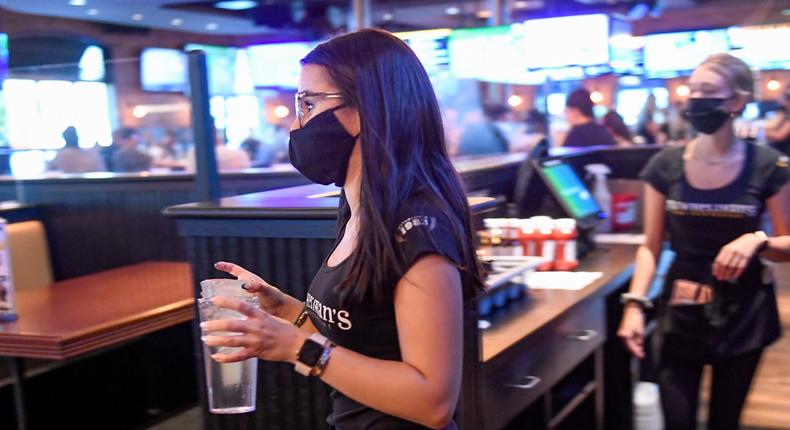 A server carries drinks to a table at P.J. Whelihan's restaurant and pub in Spring Township, Pennsylvania.Ben Hasty/MediaNews Group/Reading Eagle via Getty Images