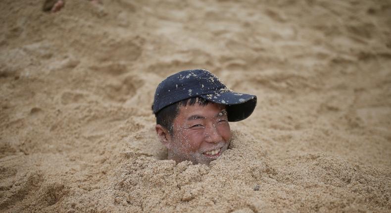 man buried in sand