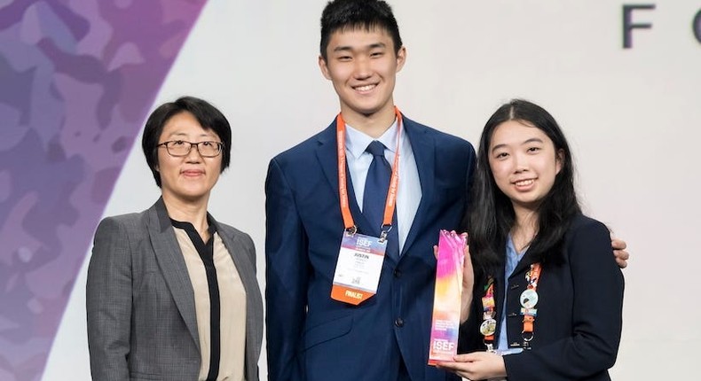 Victoria Ou (right) and Justin Huang (middle) won first place in their category and also snagged one of the top $50,000 prizes for their invention.Society for Science/Chris Ayers