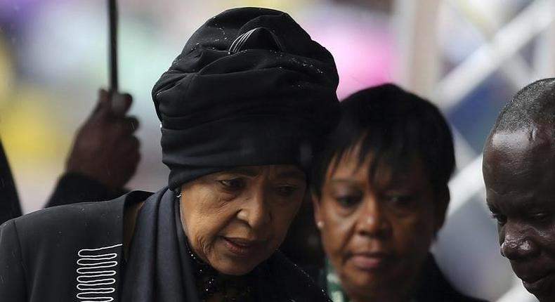 Former South African President Nelson Mandela's ex-wife Winnie Mandela (L) arrives at the First National Bank (FNB) Stadium, also known as Soccer City, ahead of the national memorial service for Nelson Mandela in Johannesburg December 10, 2013. 