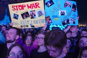 REFUSENIKS Spectators hold up posters during an antiwar concert by Russian musicians Noize MC and Monetochka in Warsaw, Poland, 2022