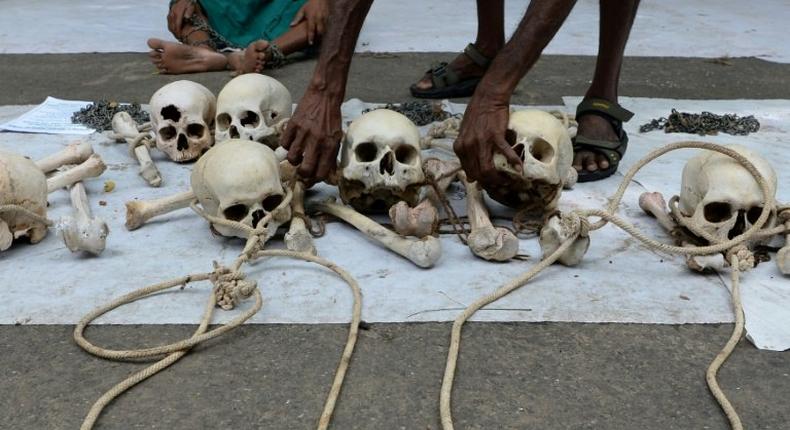 An Indian farmer from Tamil Nadu state arranges human skulls, said to belong to farmers who had committed suicide, during a protest in New Delhi on August 1, 2017
