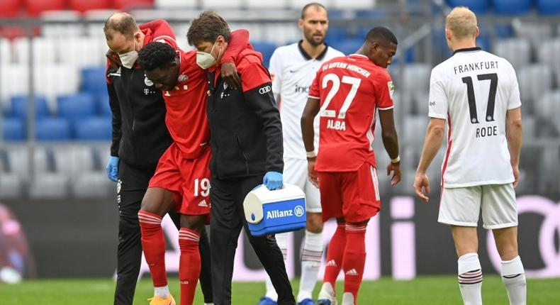 Alphonso Davies is helped off after tearing ankle ligaments on Saturday