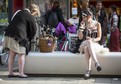 Participant of the Wave and Goth festival sits in the downtown pedestrian zone in Leipzig