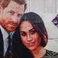 A girl waves a flag next to a LEGO brick mosaic of Britain's Prince Harry and Meghan Markle in Windsor