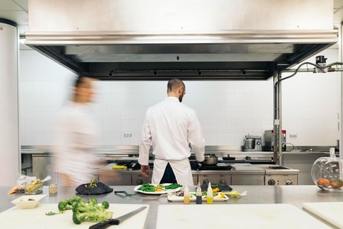 Two professionals chefs cooking together.