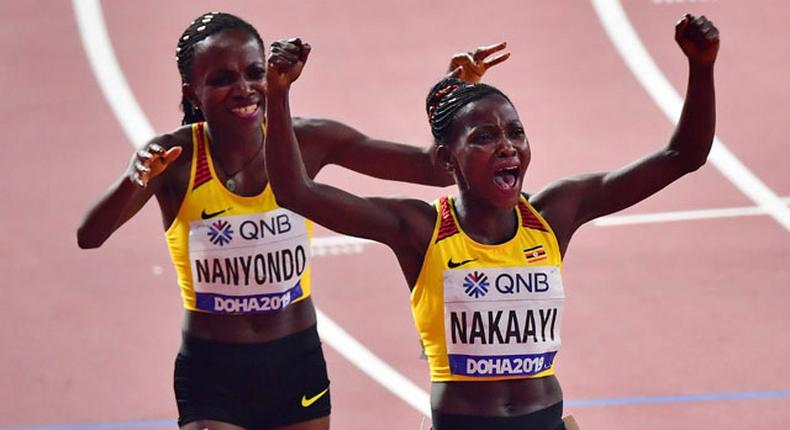 Halimah Nakaayi and Winnie Nanyondo celebrate winning the 800m finals in Doha