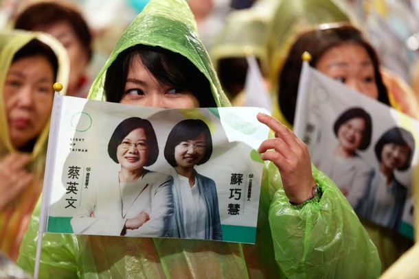 People hold flags in support of Democratic Progressive Party chairperson and presidential candidate 