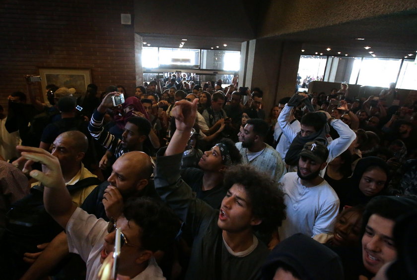 Demonstrators confront a man they believe to be Robert Black, the Chief Executive of KCTMO, outside 