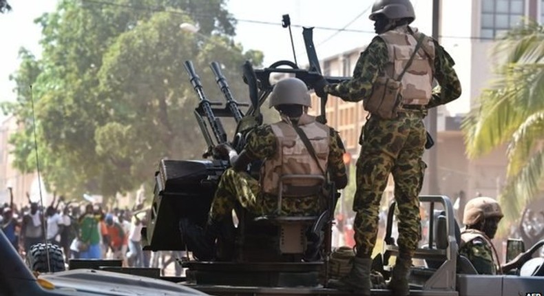 Burkina Faso troops try to disperse protesters in Ouagadougou on 30 October 2014.