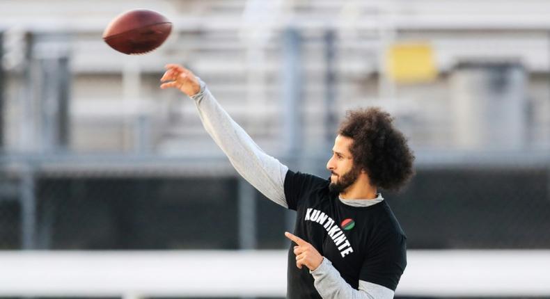 Colin Kaepernick makes a pass during a Saturday workout after ditching an NFL-planned private training session for his own public workout at a nearby high school field