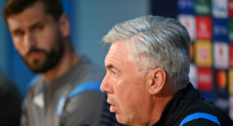 Napoli coach Carlo Ancelotti (R) and Spanish forward Fernando Llorente (L) attend a press conference before their Champions League opener against Liverpool.