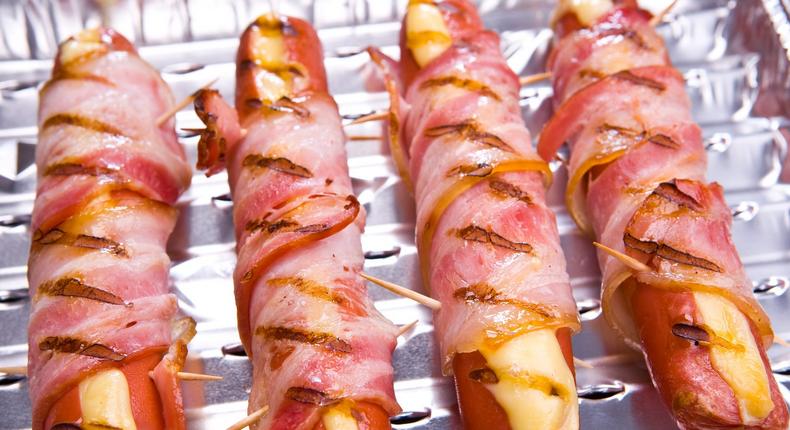 The only thing better than a classic hot dog is one stuffed with cheese and wrapped in bacon.kivoart/Getty Images