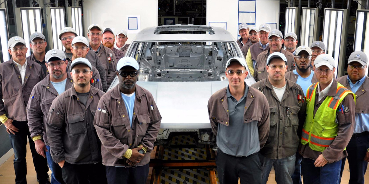 Volkswagen employees with the SUV test body.