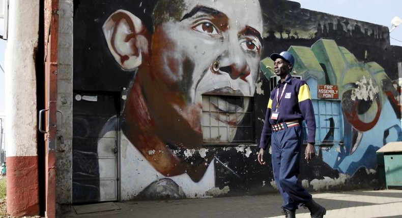 A security guard walks past a wall mural depicting U.S. President Barack Obama outside the Go-Down Art Centre in Kenya's capital Nairobi, July 17, 2015.    REUTERS/Thomas Mukoya