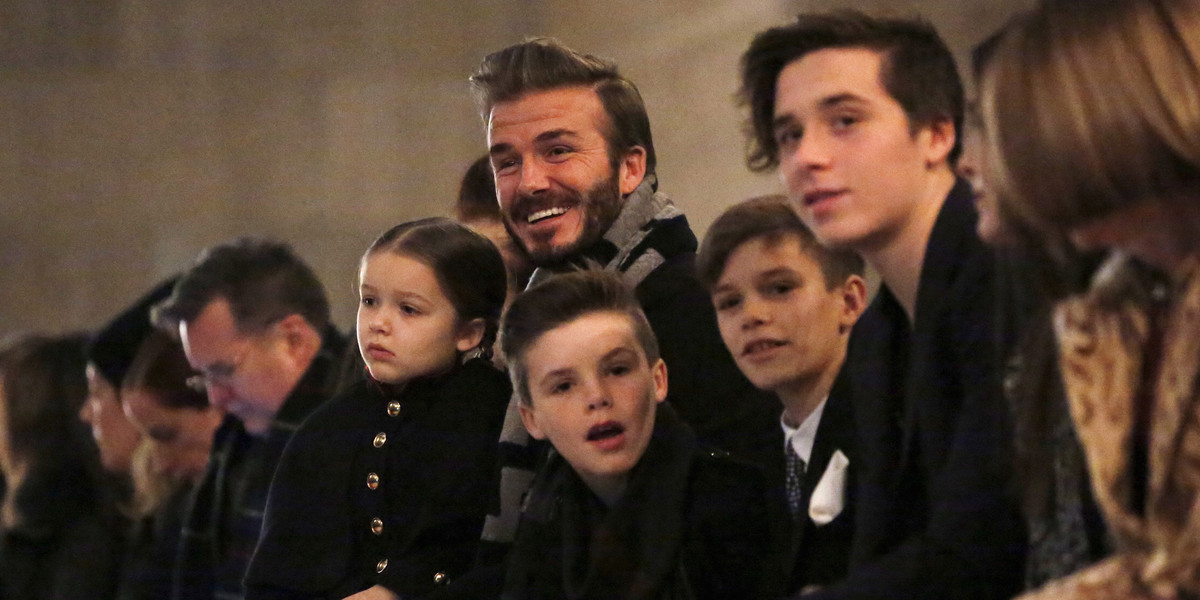 David Beckham sits with children Harper, Cruz, Romeo, and Brooklyn.