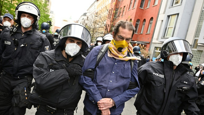 Police remove a demonstrator during he anti-confinement protest in Berlin