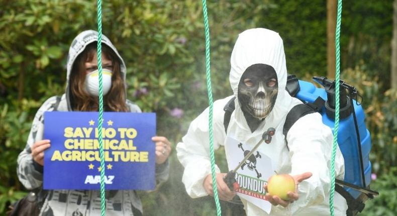 Demonstrators protest against the use of weedkiller glyphosate in Brussels on May 18, 2016