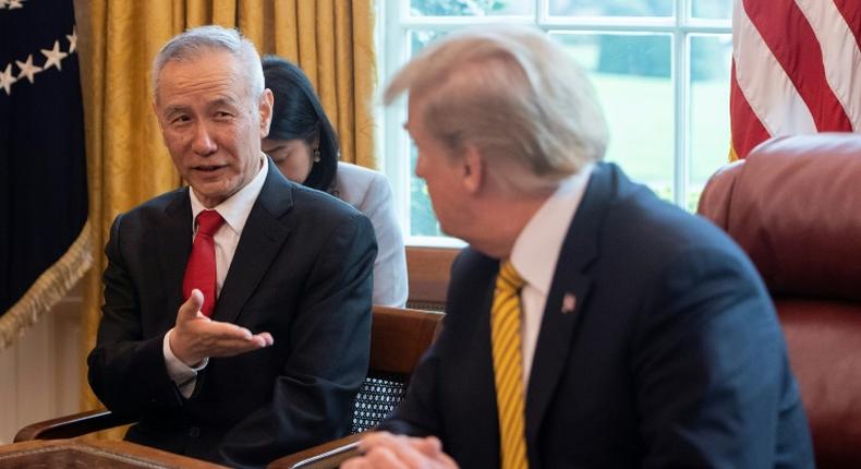 China's Vice Premier Liu He (L) speaks with US President Donald Trump during a trade meeting in the Oval Office at the White House in Washington in April 2019