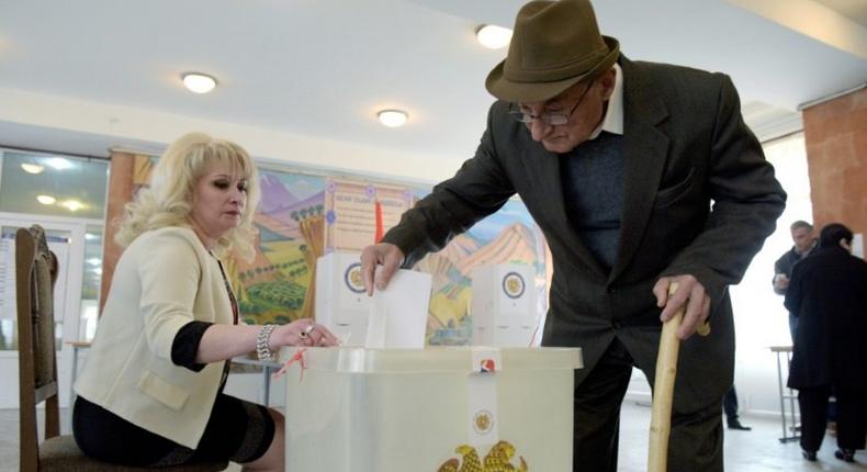 An elderly man casts his ballot at a polling station in Yerevan, the Armenian capital, in legislative elections. It is the first ballot since the adoption of constitutional reforms aimed at transforming the ex-Soviet country into a parliamentary republic