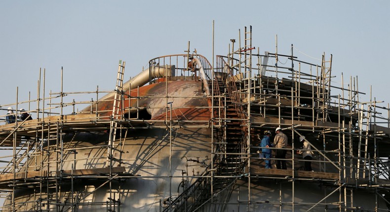 FILE PHOTO: Workers are seen at the damaged site of Saudi Aramco oil facility in Abqaiq, Saudi Arabia, September 20, 2019. REUTERS/Hamad l Mohammed