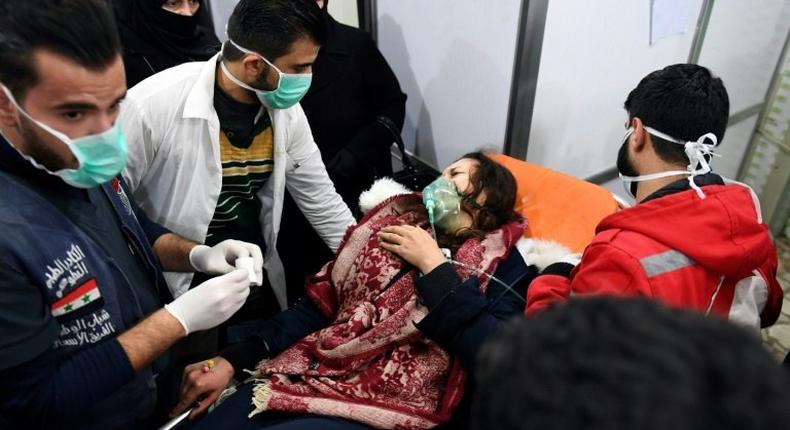 A Syrian woman receives treatment at a hospital after an assault on Aleppo, which Russia claimed was a chemical attack by rebels