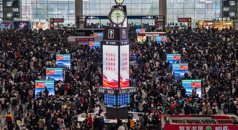 Travellers crowd at the gates and wait for trains at the Shanghai Hongqiao Railway Station during the peak travel rush for the upcoming Chinese New Year holiday on January 15, 2023 in Shanghai, China.Kevin Frayer/Getty Images