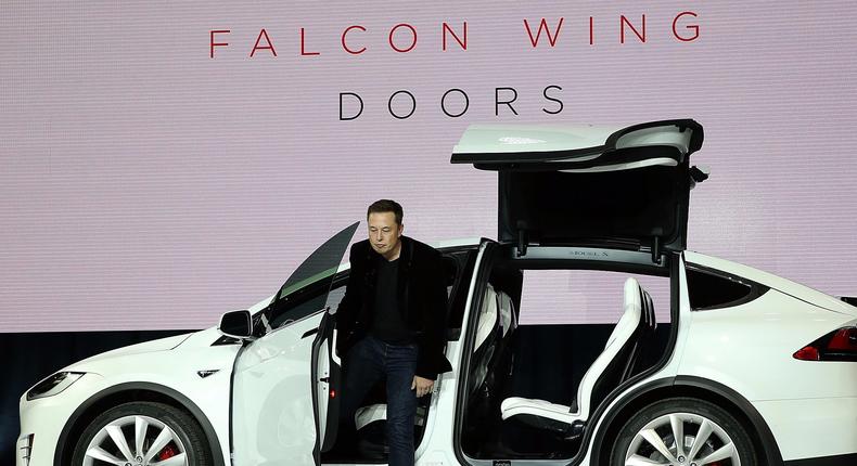 Tesla CEO Elon Musk demonstrates the falcon wing doors on the new Tesla Model X Crossover SUV during a launch event on September 29, 2015 in Fremont, California. After several production delays, Elon Musk officially launched the much anticipated Tesla Model X Crossover SUV.