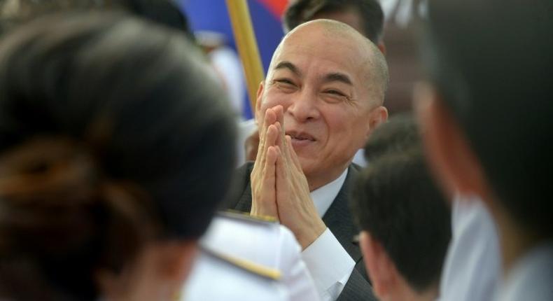 King Norodom Sihamoni (C) is largely respected in Cambodia, where he is seen as above the political fray