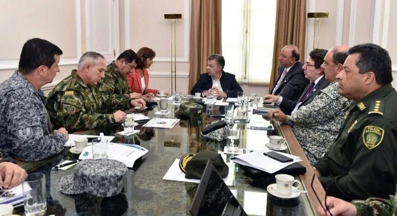President Juan Manuel Santos (C) chairing a meeting with Foreign Minister Maria Angela Holguin (1-L), Defense Minister Luis Carlos Villegas (1-R) to review information about alleged Venezuelan military incursion near the border between both countries