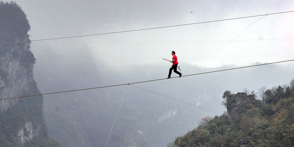 Freddy Nock of Switzerland walks on a tightrope during a competition in Wulong County, Chongqing.