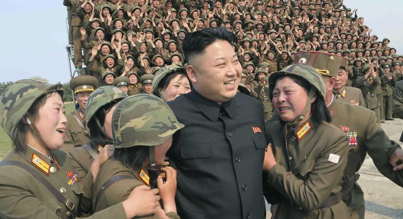 North Korean Supreme Leader Kim Jong Un greets a women's subunit during a rocket-launching drill.