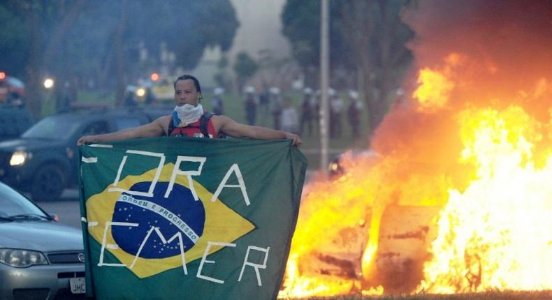 Students clash with police during a protest in front of the Congress in Brasilia on November 29, 2016 against the bill that freezes government spending for 20 years