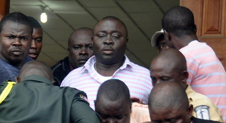 Liberia's parliamentary speaker Alex Tyler (C) leaves the Justice Court on May 25, 2016 in Monrovia 