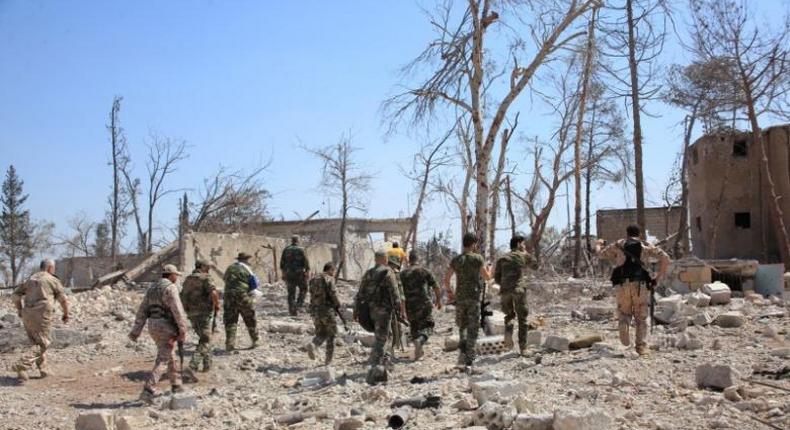 Forces loyal to Syria's President Bashar al-Assad walk at a military complex, after they recaptured areas in southwestern Aleppo that rebels had seized last month, Syria, in this handout picture provided by SANA on September 5, 2016.