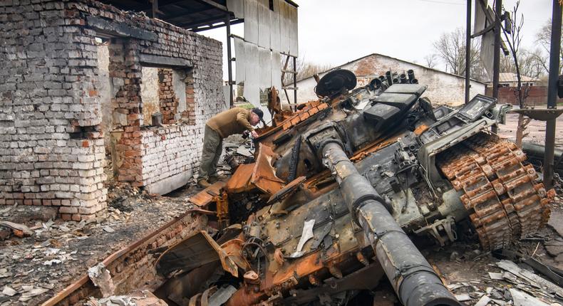 A man looks at russian T-72 tank destroyed during Russia's invasion to Uktaine, Ivanivka village, Chernihiv area, Ukraine, on April 20, 2022.