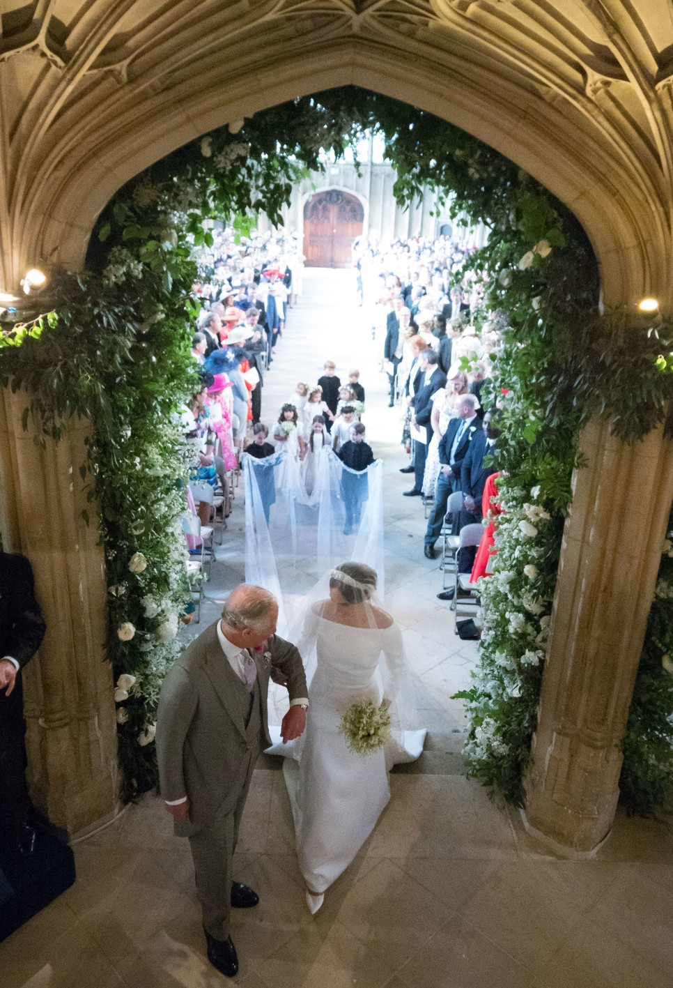 Meghan Markle walks up the aisle with the Prince Charles, Prince of Wales at St George's Chapel at Windsor Castle during her wedding to Prince Harry on May 19, 2018 in Windsor, England.
