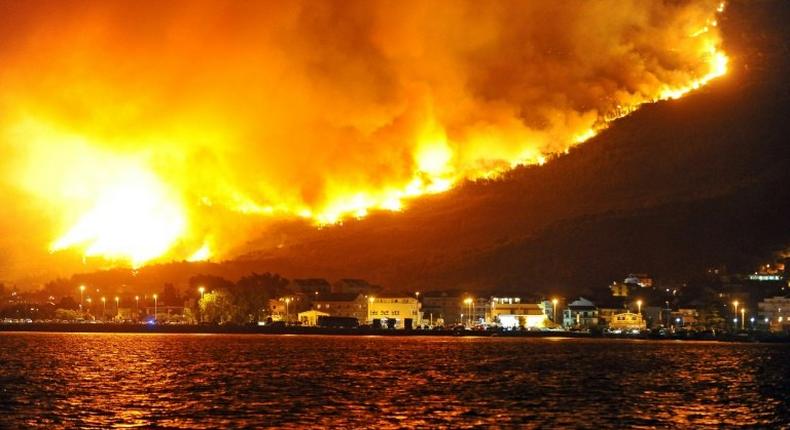Smoke and flames rise from a blaze above Podstrana, near the Croatian Adriatic coastal town of Split, on July 18, 2017