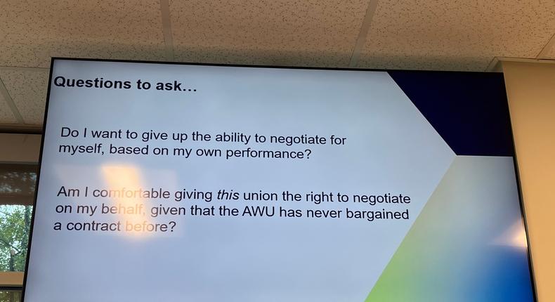 YouTube Music workers at Cognizant's Austin, TX office are surrounded by screens that cycle through anti-union messaging.Sam Regan