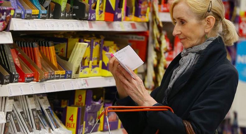 A shopper checks her shopping list in a supermarket in London, Britain April 11, 2017.