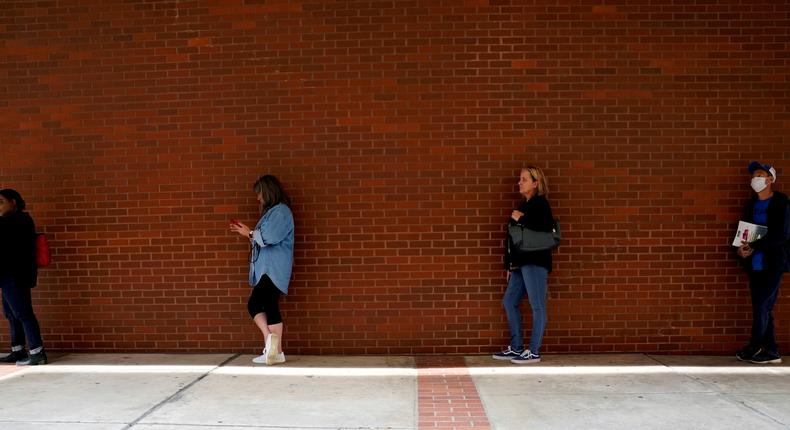 People who lost their jobs during the pandemic wait in line to file for unemployment benefits in Arkansas.