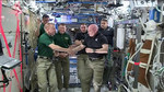 NASA astronauts Scott Kelly and Tim Kopra shake hands as Kelly turns over command aboard the International Space Station